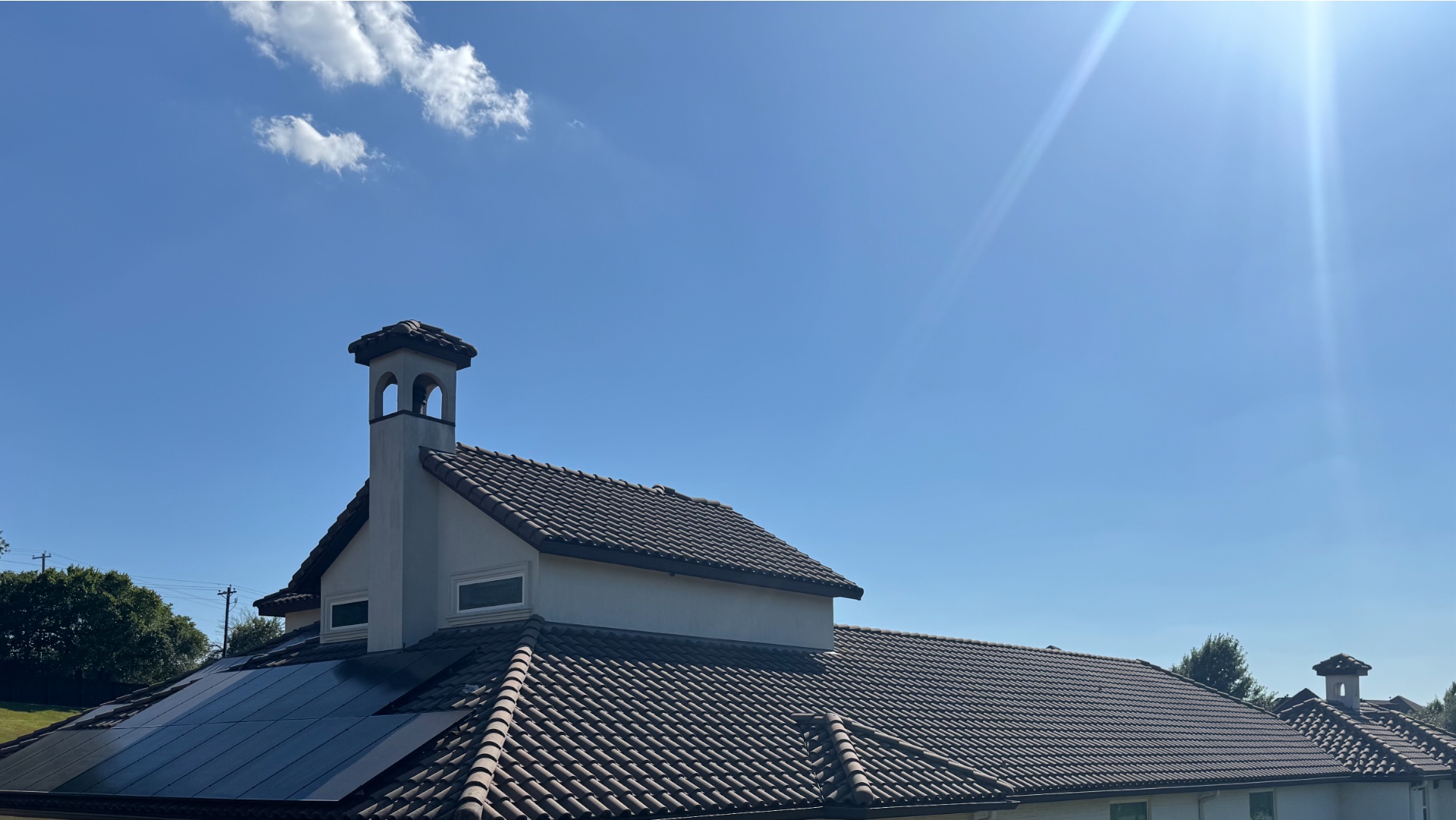 Concrete tile roof detail with solar panels on a North Texas home