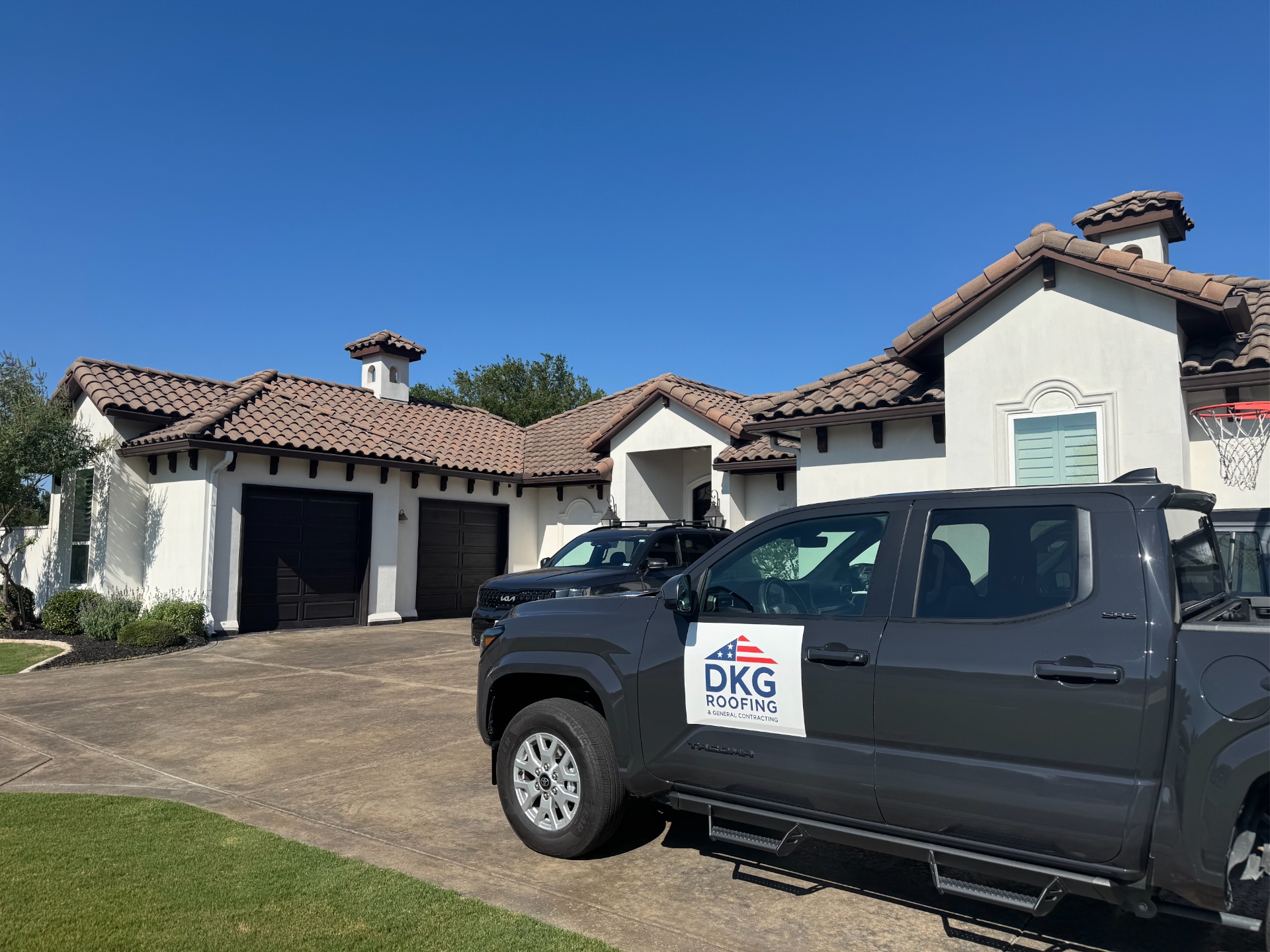 DKG Roofing truck parked at a North Texas home