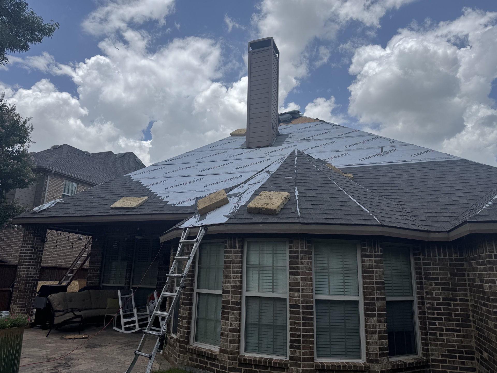 Hip roof under synthetic underlayment during a DKG roof installation in North Texas