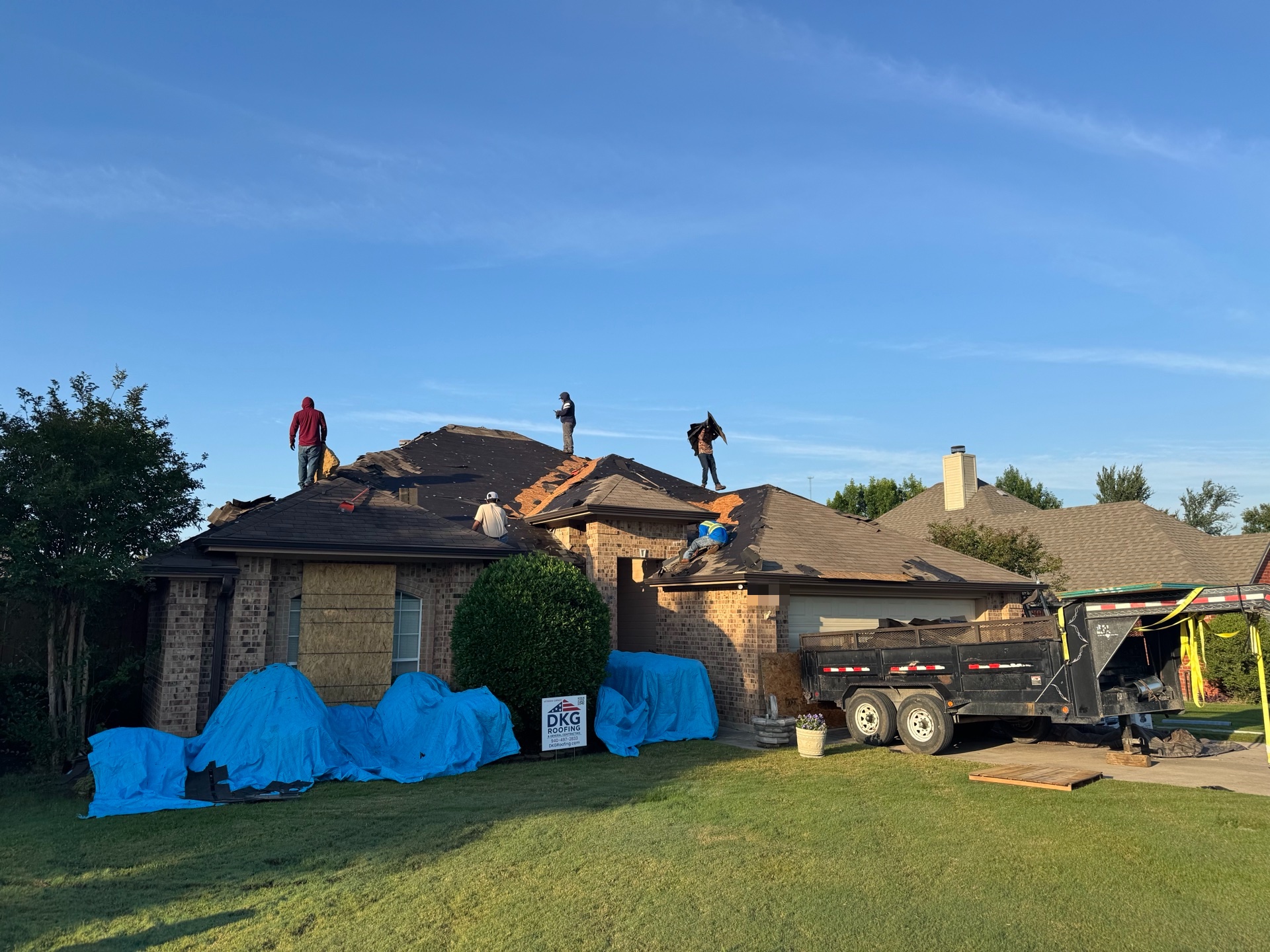 DKG roofing crew working on a residential job site